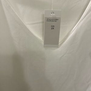 White size 2x with gorgeous ruffle sleeves.  Stretchy fabric.  NWT